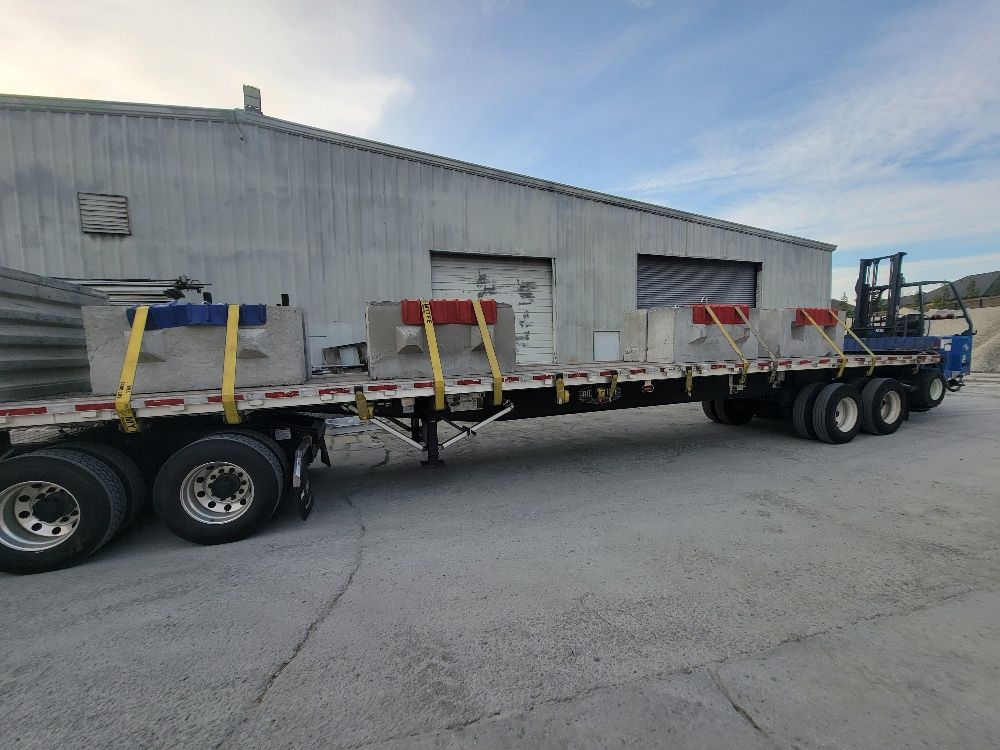 Concrete counterweights filling only part of a flatbed deck — a true partial load